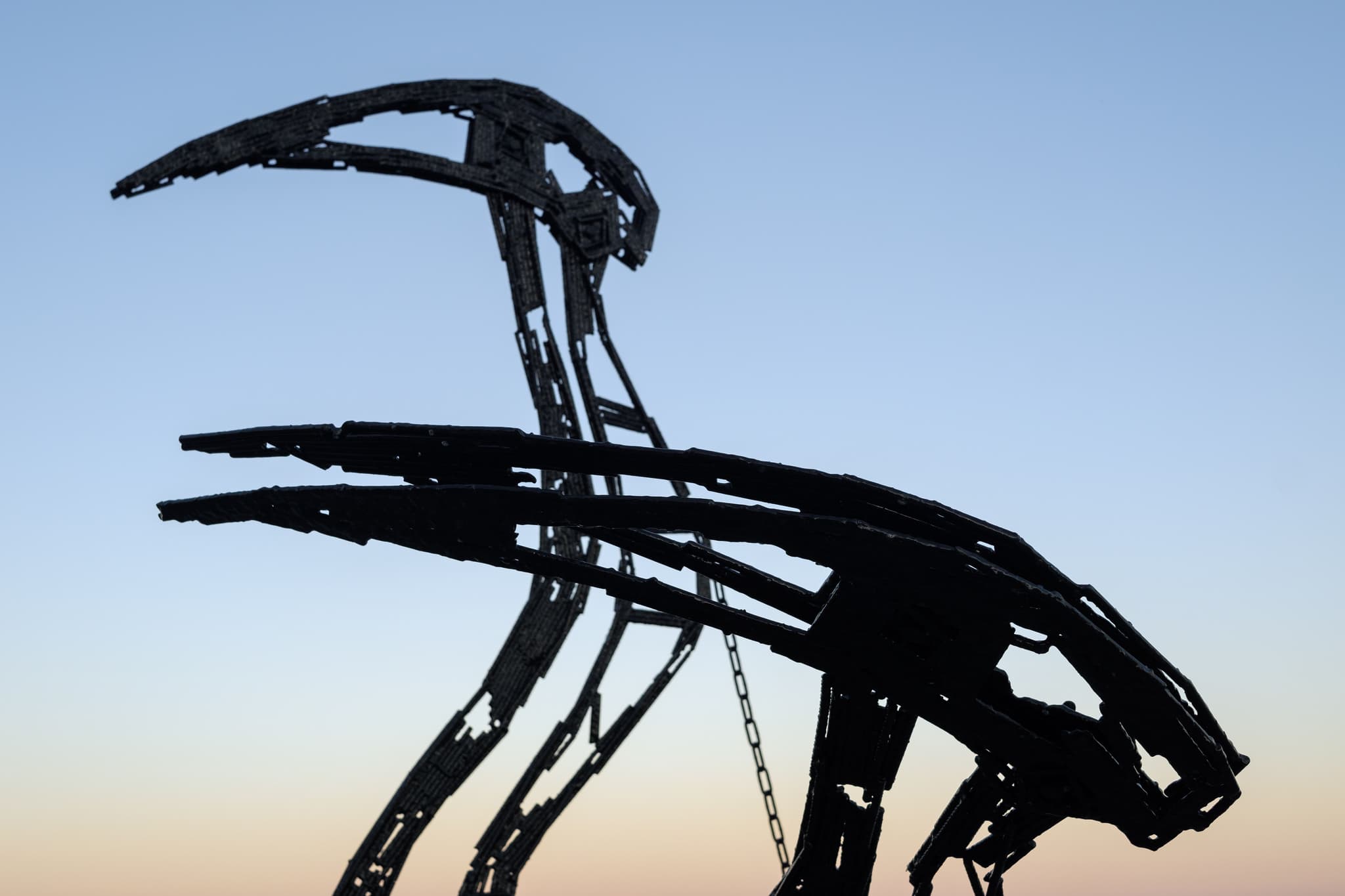 Make it Burn then Hold silhouetted against the Lisbon sky